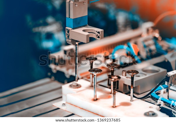 Automated Assembly line of\
mechanical engineering. Shallow depth of field. The background is\
blurred.