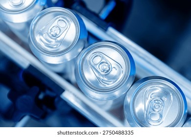Automated beer canning process in modern brewery, blue neon light top view.