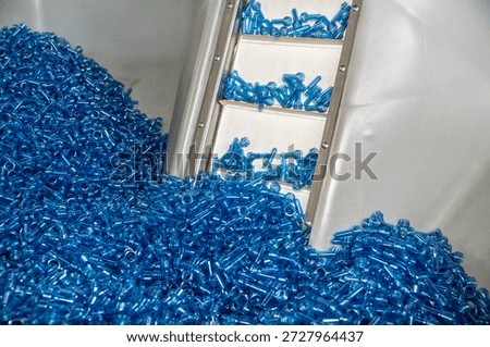 Automated elevator for transporting plastic preforms to the production line.