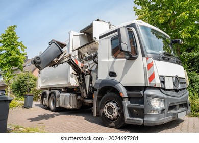 Automated Garbage Collection - Hydraulic Side Loader Of A White Garbage Truck Grabs The Garbage Can To Empty It