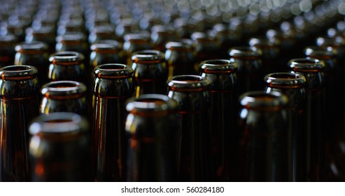 Automated industrial chain of bottles for beer and alcoholic and soft drinks. The concept of industry and sectors of automation and robots. - Powered by Shutterstock