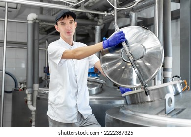 Automated Milk Production Process At The Factory. Worker On A Milk Factory