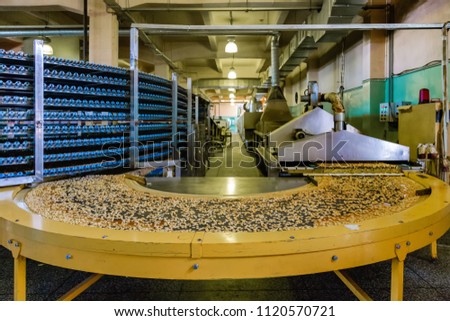 Automated production line of modern bakery. Ovens, conveyor line machine and other eqipment for baking crackers and cookies.