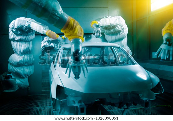 Automated robotic arm is painting on the automobile\
manufacturing line