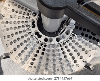 An automated sample analyzer prepares to process a batch of water quality samples arranged in a circular carousel. The organized test tubes and precision instrument highlight the technology used to support environmental monitoring, compliance testing, and analytical measurement.
