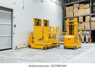 Automatic aerial order pickers at warehouse interior - Powered by Shutterstock