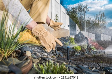 Automatic Backyard Garden Lawn Sprinkler Installation And Adjusting Performed By Professional Garden Technician. Close Up Photo. 