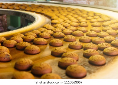 Automatic Bakery Production Line With Sweet Cookies On Conveyor Belt Equipment Machinery In Confectionary Factory Workshop, Industrial Food Production