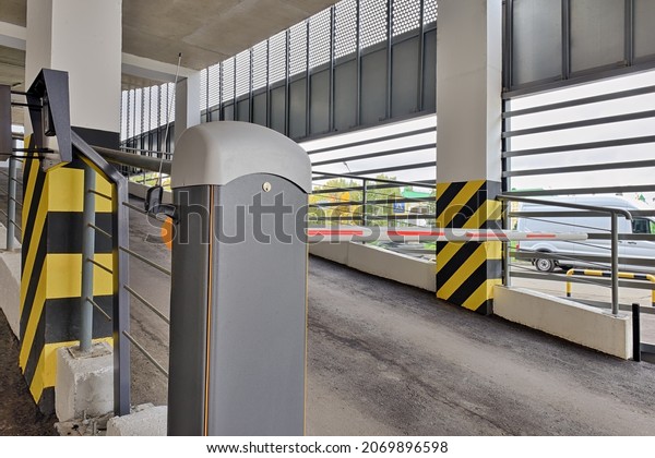 Automatic barrier gate at\
the entrance to a typical multi-storey car park. Closed barrier of\
car parking
