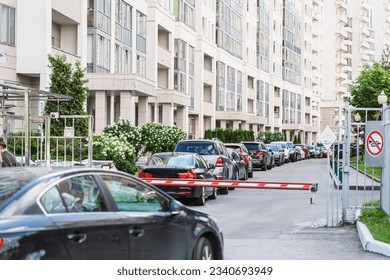 Automatic Barrier Gate, entry system, private parking of residential building. Row of cars parked in yard