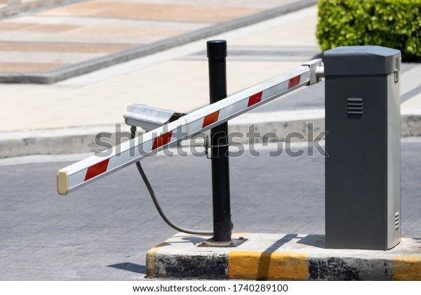 automatic\
barrier at gate for security system with\
CCTV.