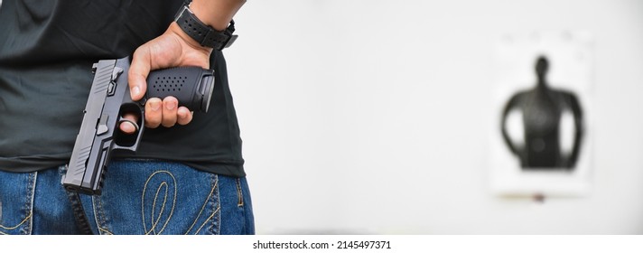 Automatic Black 9mm Pistol Gun Holding In Hand Of Shooter, Ready To Shot The Man-target Shooting Paper Ahead, Concept For Training And Practising Human To Be Body Guard, Vip Protecters And Gangsters.