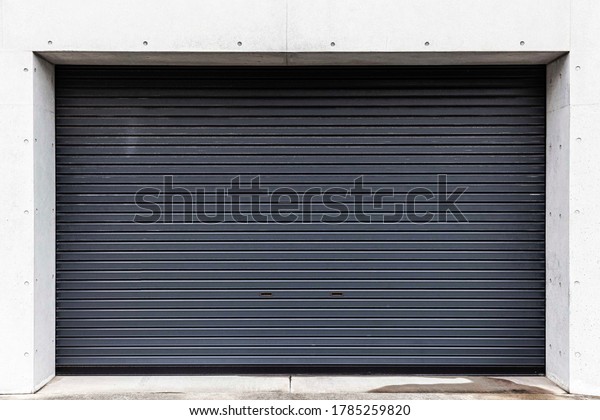 Automatic black roller shutter doors on the ground\
floor of the house