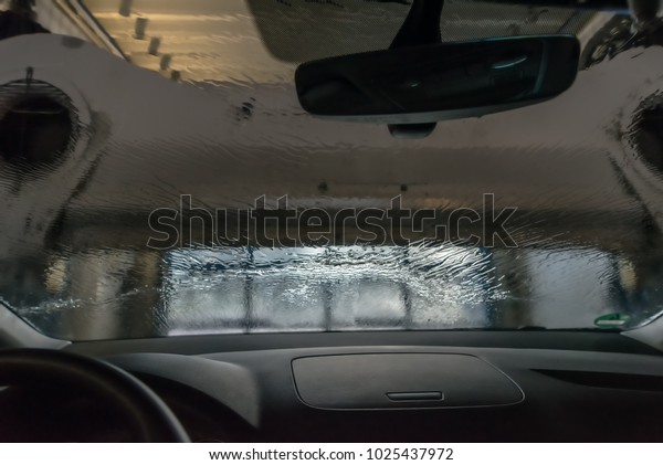 Automatic car wash. Blower\
blows the water from the car. Look out of the car. Concept:\
transport and cars.