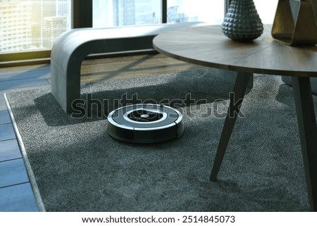 Automatic cleaning machine working. Robots vacuums cleaners on carpet in living room for cleaning pet hair and dust.