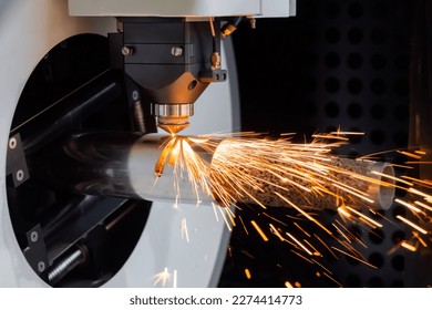 Automatic cnc laser cutting machine working with cylindrical metal workpiece with sparks at factory, plant. Metalworking, machining, industrial, equipment, technology, manufacturing concept - Powered by Shutterstock