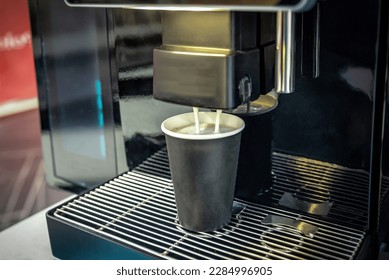 An automatic coffee machine makes delicious scented coffee with milk