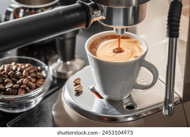 Automatic coffee machine. Pouring coffee into the coffee cup closeup. 
