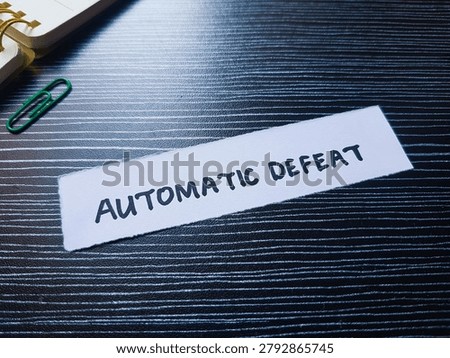 Automatic defeat writting on table background. 