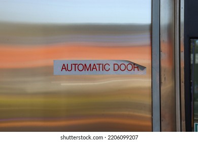 Automatic Door Sign On Door With Reflection