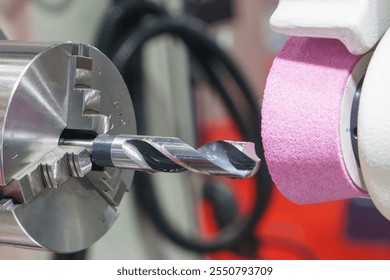 The automatic drill tool sharpener machine. The drill tool regrinding process by abrasive stone. - Powered by Shutterstock