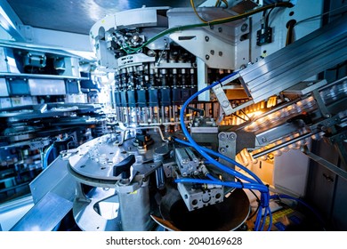 Automatic filling machine pours water into plastic PET bottles at modern beverage plant. - Powered by Shutterstock