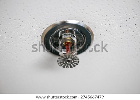 Automatic fire sprinkler head installed on ceiling for fire protection and safety in building