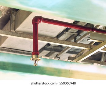 Automatic Fire Sprinkler in red water pipe System - Shutterstock ID 550060948
