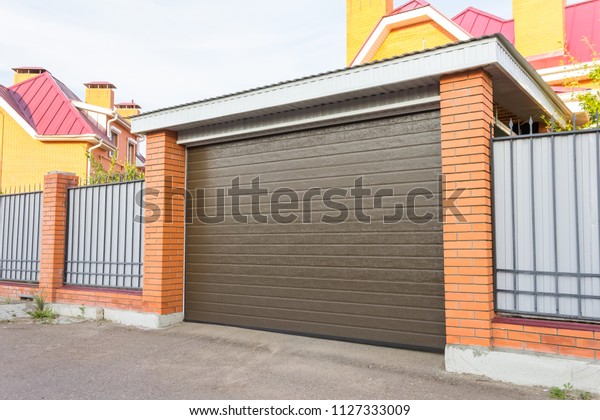 Automatic gate to the garage\
is brown