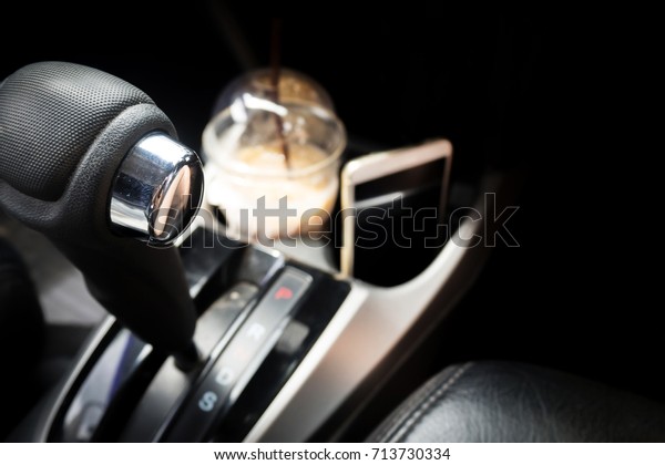 Automatic gear in Drive function. With coffee and\
mobile phone are background. Concept of refreshment driving with\
coffee and moving forward with technology. With dark vignette and\
copy space.