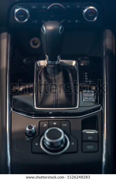automatic gear stick and dial gear shift control\
inside the car. interior automobile design. vehicle movement\
control concept. How to preserve the wear and tear of the motor car\
concept.