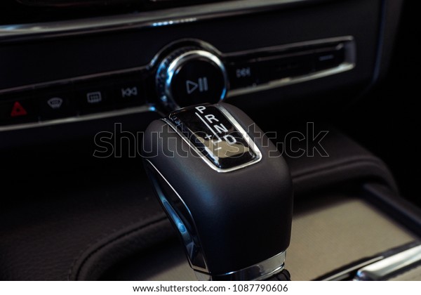 Automatic gear stick with manual selection option.\
Modern Luxury car inside. Interior of prestige modern car.\
Comfortable leather seats. Light brown perforated leather cockpit.\
Automatic gear stick.
