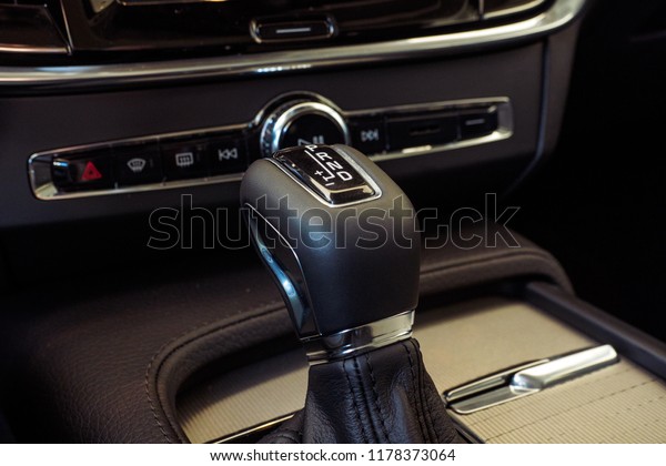 Automatic gear stick with manual selection option.
Modern Luxury car inside. Interior of prestige modern car.
Comfortable leather seats. Light brown perforated leather cockpit.
Automatic gear shift.