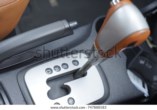 Automatic gear stick with manual\
selection option.Detail on a automatic gear shifter in a luxury\
car.