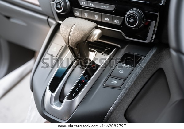 automatic gear stick of a modern car, car interior\
details.\
Icon near a floor selection lever of car with automatic\
transmission gear\
shift.