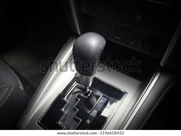 Automatic gear stick of a modern car in\
drive position, car interior details, close up\
view