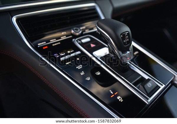 Automatic gearbox stick and various control buttons\
in sprots car.