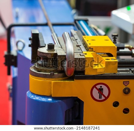 Automatic industrial round bender machine for metal wire rod and tube. Industrial metalwork machinery.