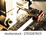 Automatic key cutting machine surrounded by metal shavings