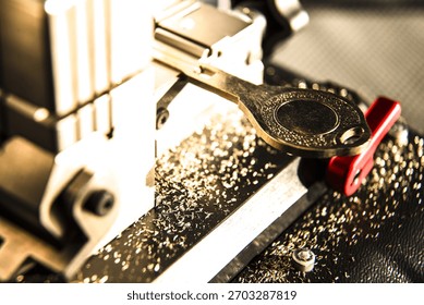 Automatic key cutting machine surrounded by metal shavings