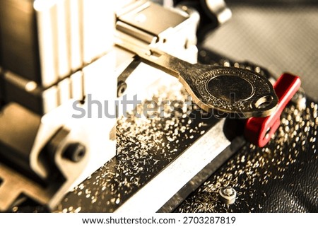 Automatic key cutting machine surrounded by metal shavings