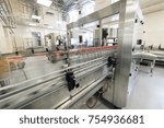 Automatic labeling machine during operation. Factory for the production of alcoholic beverages.