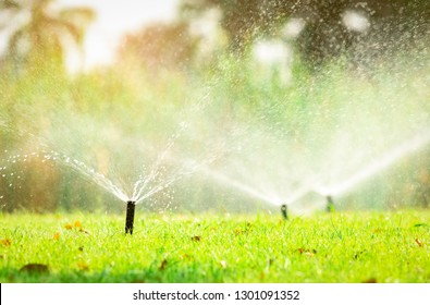 Automatic Lawn Sprinkler Watering Green Grass. Sprinkler With Automatic System. Garden Irrigation System Watering Lawn. Sprinkler System Maintenance Service. Home Service Irrigation Sprinkler.