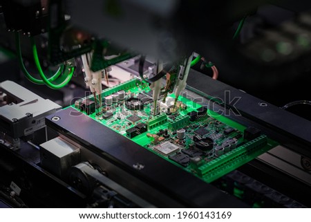 Automatic machine for diagnostics of electronic boards, production. Small needles are checking the electronic circuit. Creation of electronic boards and microcircuits. Processor manufacturing.
