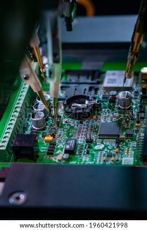 Automatic machine for diagnostics of electronic boards, production. Small needles are checking the electronic circuit. Creation of electronic boards and microcircuits. Processor manufacturing.