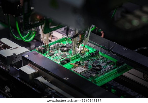 Automatic machine for diagnostics of
electronic boards, production. Small needles are checking the
electronic circuit. Creation of electronic boards and
microcircuits. Processor
manufacturing.