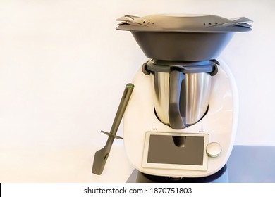 Automatic modern culinary robot with touch screen and the varoma. Close up.