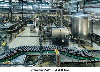Automatic modern production line at brewery. Conveyor line and vats for fermentation and pasteurization.