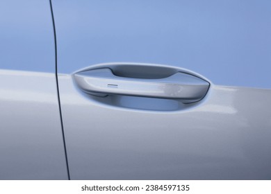 Automatic opening of a car door without a key. Keyless entry car door handle with keyless go touch sensor. Car door handle. Access button. Exterior design of a new electric luxury car.