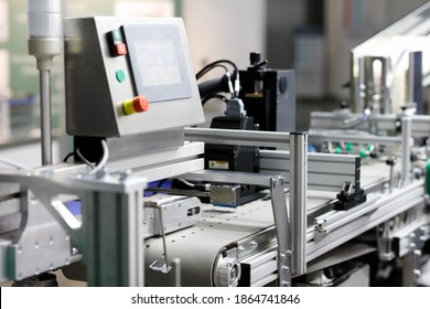 Automatic packaging belted conveyor system in a pharmaceutical plant. Selective focus.